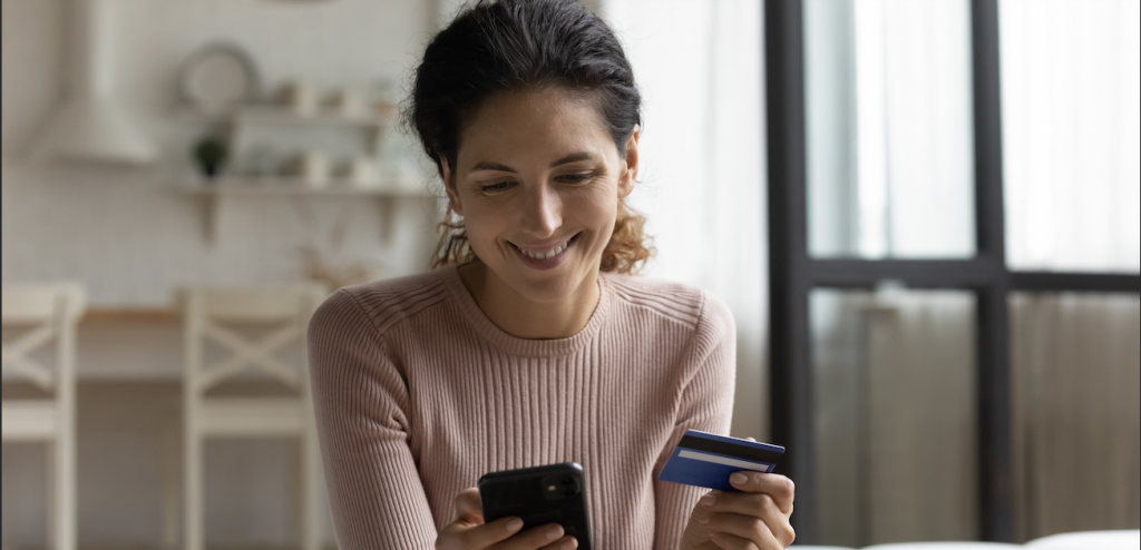 Purchase protection - Woman buying on her phone using credit card