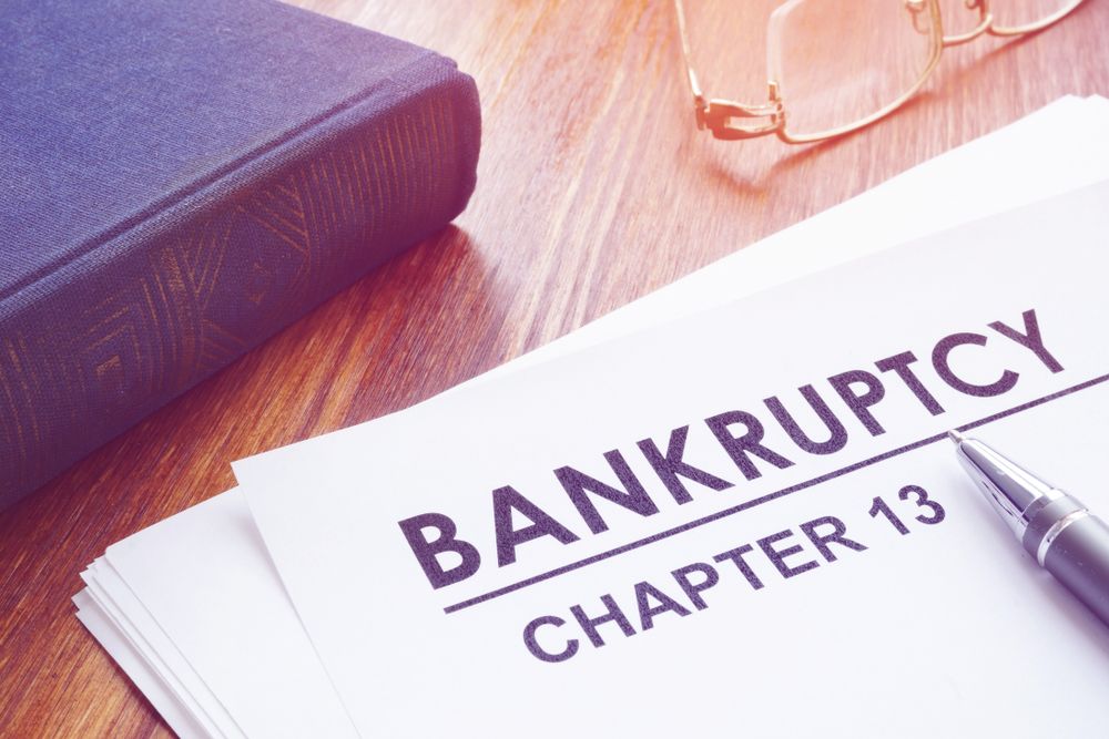 Chapter 13 bankruptcy petition and book on the table.